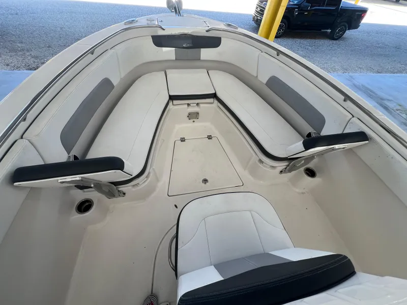 Slide: The Image of 2019 Robalo R242 Explorer boat interior with cushioned seating and storage compartments. - 13