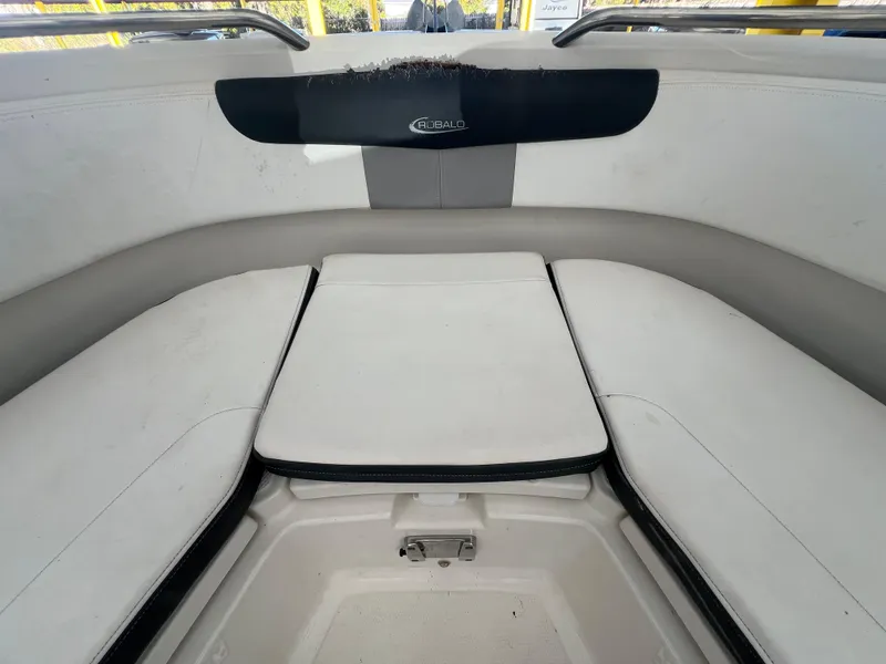 Slide: The Image of 2019 Robalo R242 Explorer boat interior with cushioned seating area. - 14