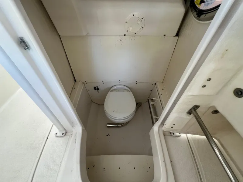 Slide: The Image of 2019 Robalo R242 Explorer boat interior with compact marine toilet. - 18
