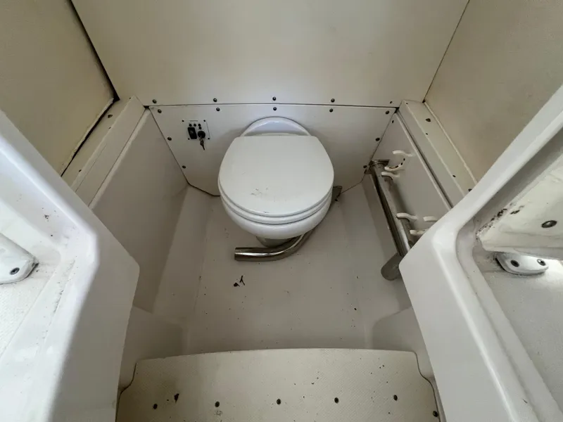 Slide: The Image of 2019 Robalo R242 Explorer boat bathroom interior with toilet. - 19