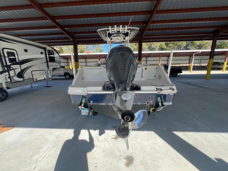Slide: The Image of 2019 Robalo R242 Explorer boat in covered storage, rear view. - 2
