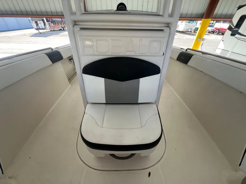 Slide: The Image of 2019 Robalo R242 Explorer boat interior with cushioned seating. - 20