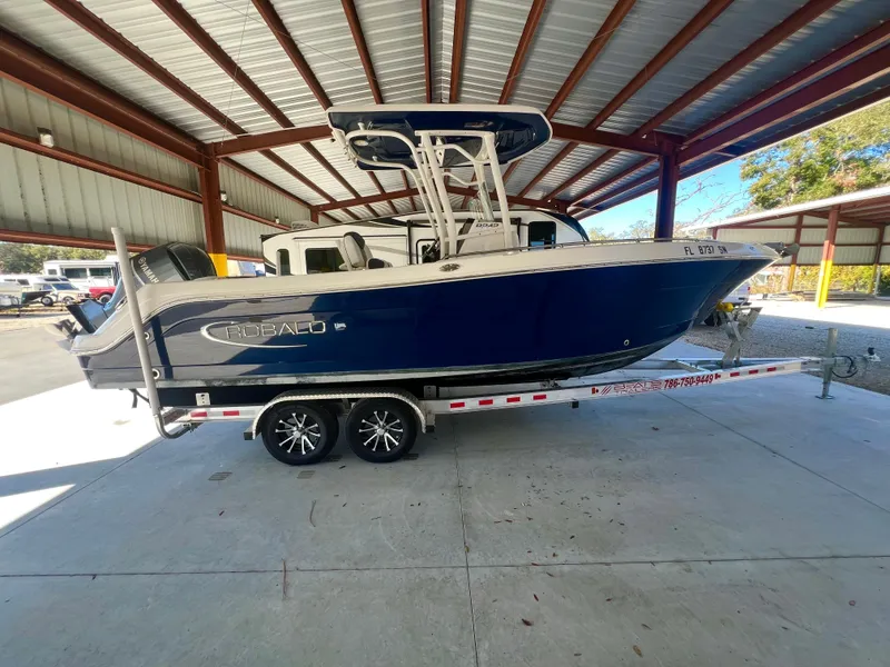 Slide: The Image of 2019 Robalo R242 Explorer boat on trailer in covered storage area. - 4
