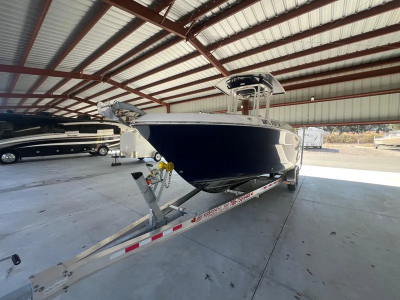 Slide: The Image of 2019 Robalo R242 Explorer boat on trailer in covered storage. - 7