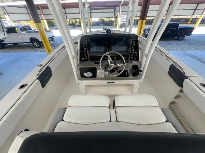 Slide: The Image of 2019 Robalo R242 Explorer boat cockpit with steering wheel and dual displays. - 9