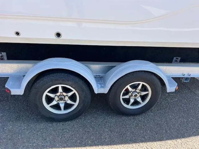 Slide: The Image of 2018 Sea Fox 248 Commander trailer with dual wheels on pavement. - 23