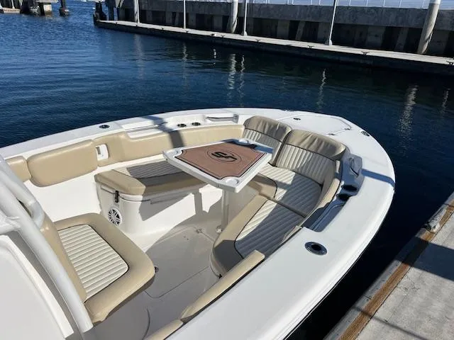 Slide: The Image of 2018 Sea Fox 248 Commander boat interior with seating and table, docked at marina. - 3