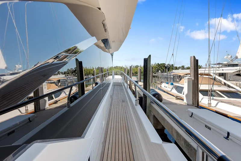 Slide: The Image of Astondoa 66 yacht deck, 2022 model, docked at marina under clear blue sky. - 10