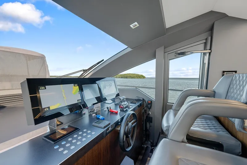 Slide: The Image of Astondoa 66 yacht helm, 2022 model, featuring modern navigation equipment and luxurious seating. - 16