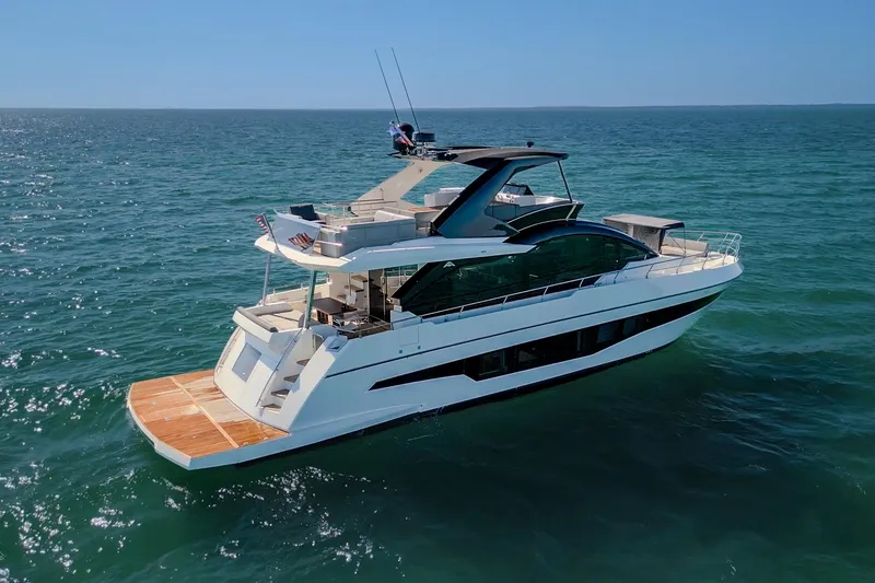 Slide: The Image of Astondoa 66 yacht, 2022 model, cruising on open sea under clear blue sky. - 2