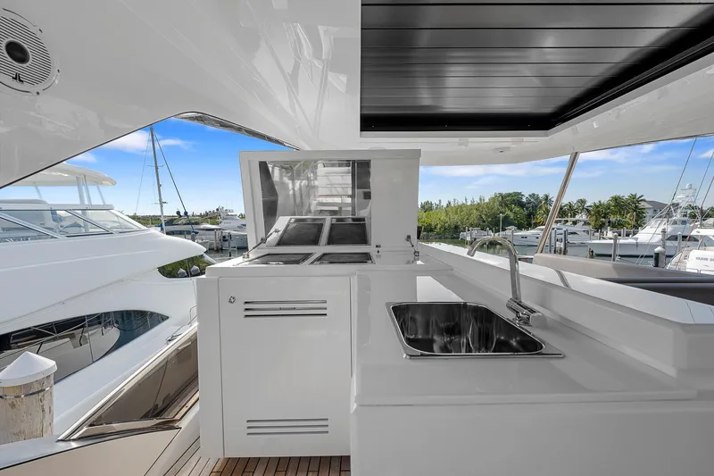 Slide: The Image of Astondoa 66 yacht 2022, sleek outdoor kitchen with sink and grill, marina view. - 32
