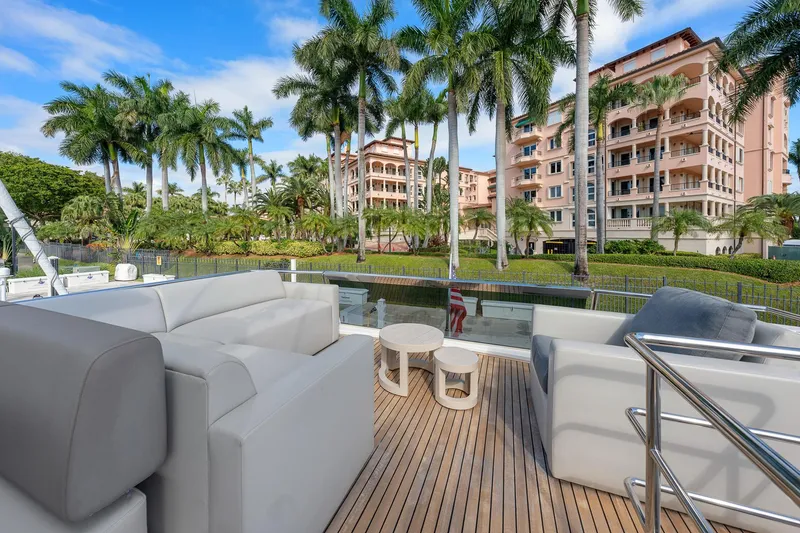 Slide: The Image of Luxurious 2022 Astondoa 66 yacht deck with palm trees and waterfront view. - 37