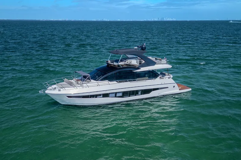 Slide: The Image of Astondoa 66 yacht, 2022 model, cruising on open sea under clear blue sky. - 4