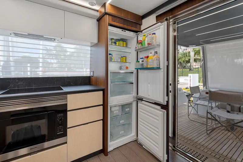 Slide: The Image of Modern kitchen in 2022 Astondoa 66 yacht with open fridge and microwave. - 42