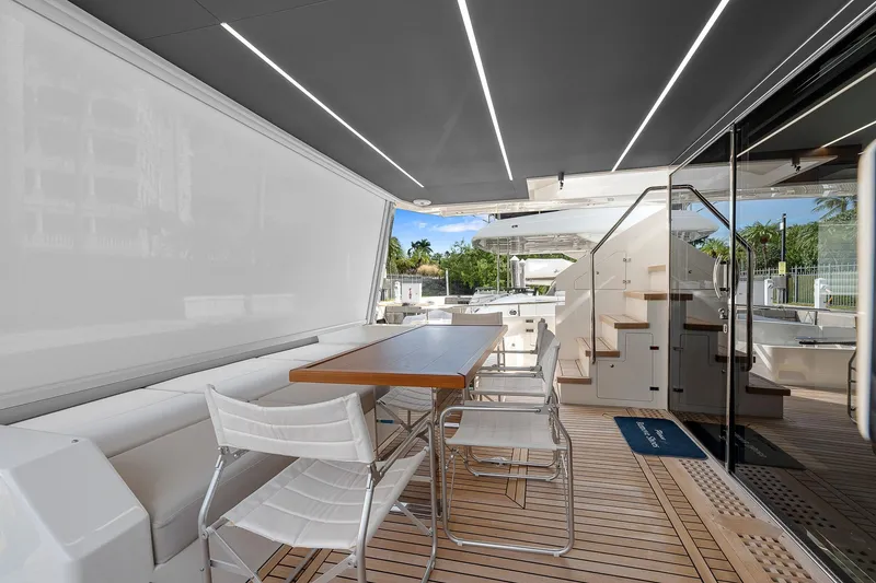 Slide: The Image of Astondoa 66 yacht 2022, elegant outdoor seating area with modern design and wooden flooring. - 47