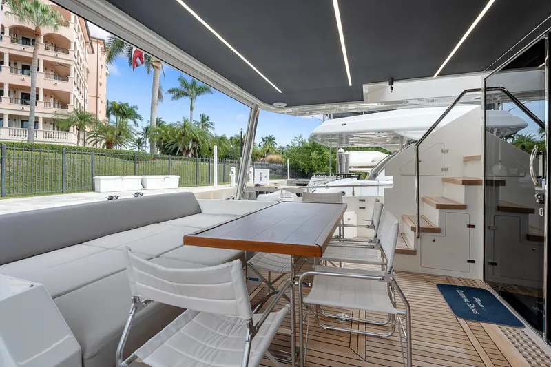 Slide: The Image of Astondoa 66 yacht 2022, elegant outdoor seating and dining area with modern design. - 48