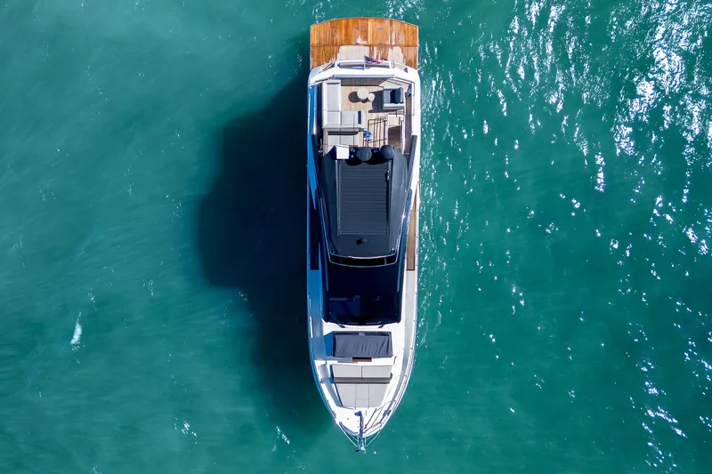 Slide: The Image of Aerial view of 2022 Astondoa 66 yacht on turquoise water. - 7