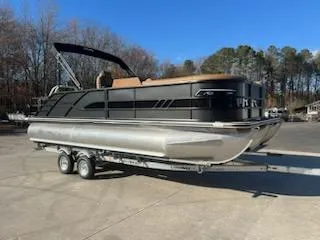 The Image of 2025 Bentley Pontoons 223 Elite Swingback Dual Captain on trailer, parked outdoors. - 1