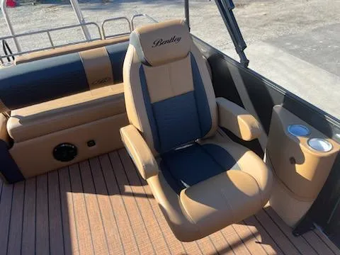Slide: The Image of 2025 Bentley Pontoons 223 Elite Swingback Dual Captain seat with cup holders and luxury design. - 9