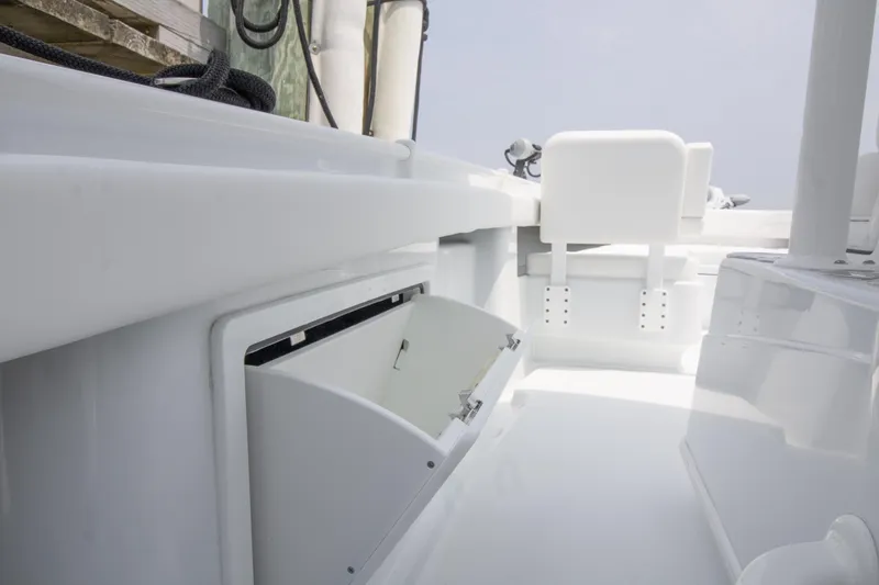 Slide: The Image of 2025 Yellowfin 26 Hybrid boat interior with open storage compartment. - 17
