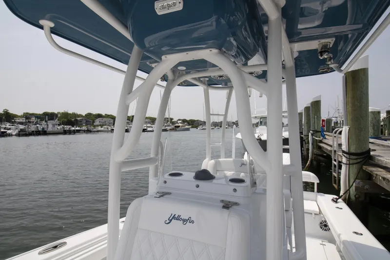 Slide: The Image of 2025 Yellowfin 26 Hybrid boat docked at marina, showcasing sleek design and spacious interior. - 2