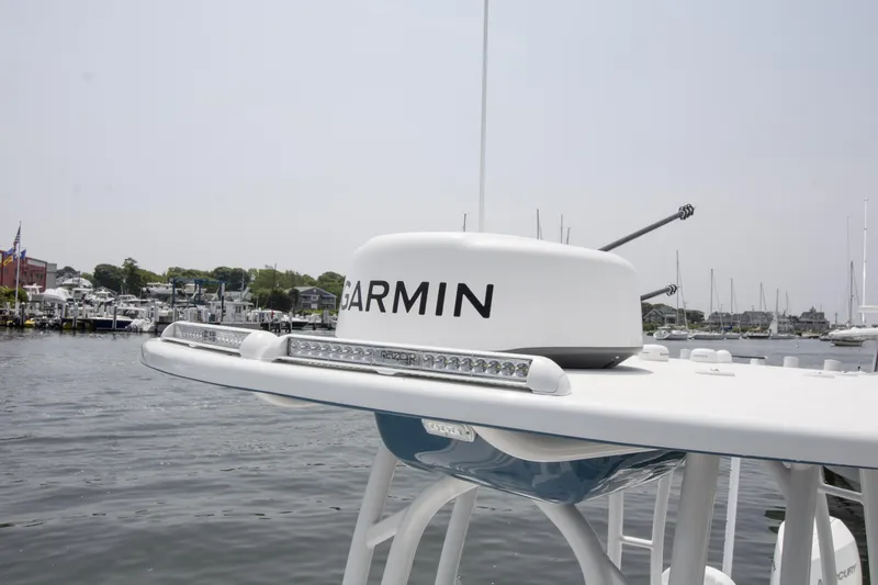 Slide: The Image of 2025 Yellowfin 26 Hybrid boat with Garmin radar, docked in a marina. - 21