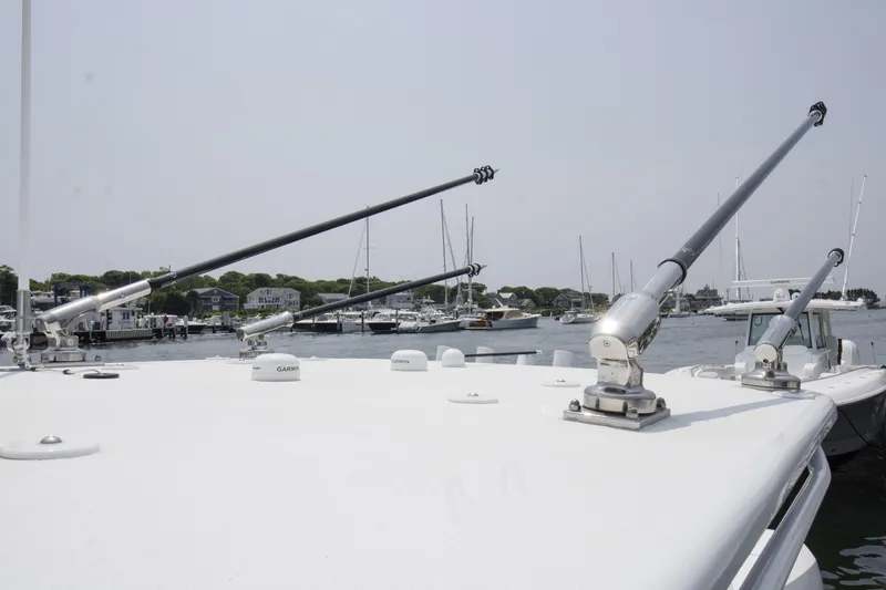 Slide: The Image of 2025 Yellowfin 26 Hybrid boat with outriggers docked at a marina. - 22