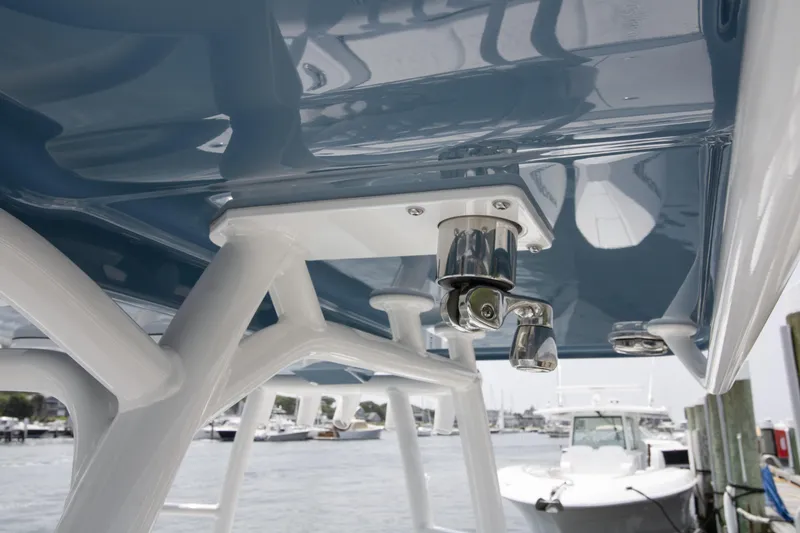 Slide: The Image of 2025 Yellowfin 26 Hybrid boat detail, showcasing sleek design and sturdy construction at a marina. - 24