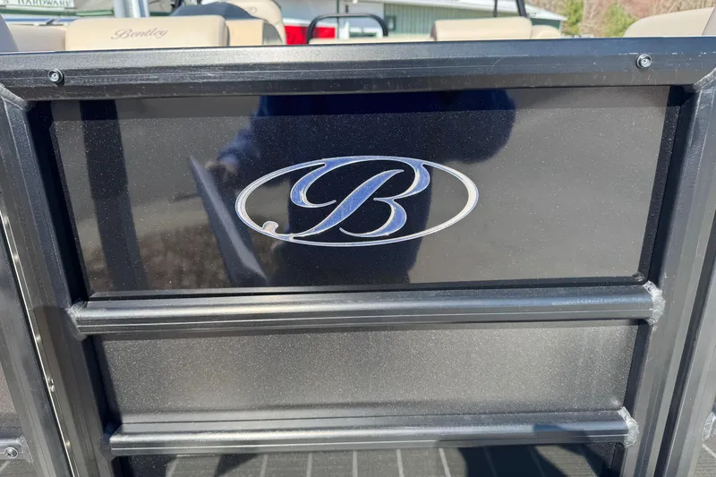 Slide: The Image of 2026 Bentley Pontoons 200 CRUISE logo on black panel, outdoor setting. - 11