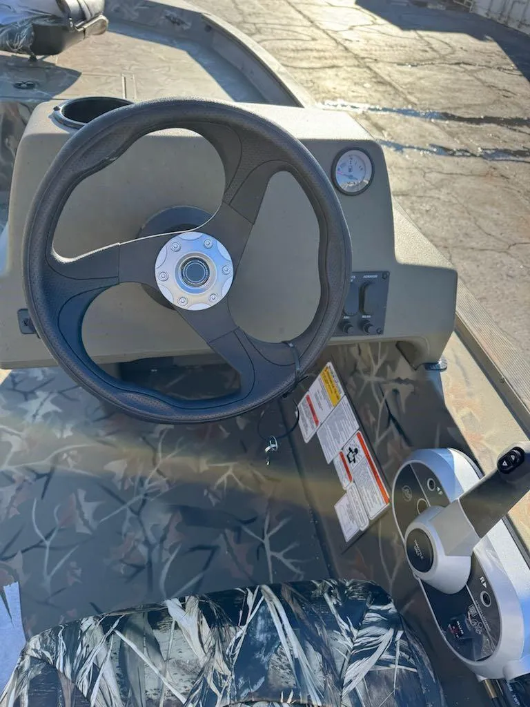 Slide: The Image of 2025 Tracker Grizzly 1754 SC boat steering console with control panel and gauges. - 35