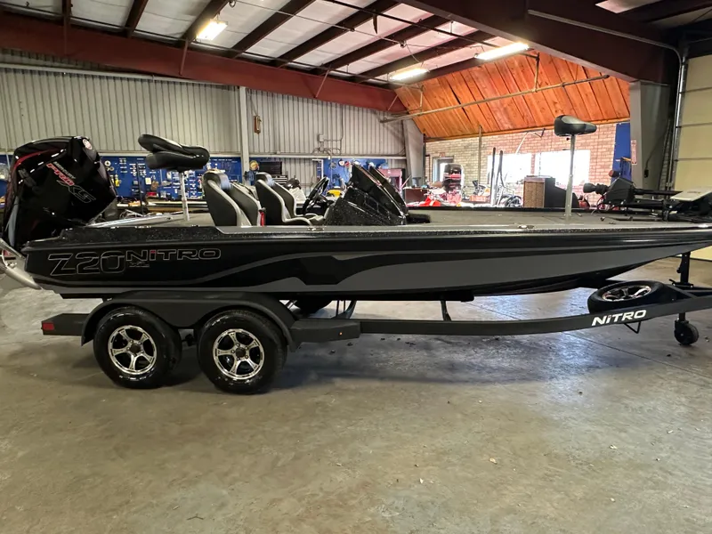 Slide: The Image of 2025 Nitro Z20 XL Pro boat in a garage, featuring sleek design and dual-axle trailer. - 2