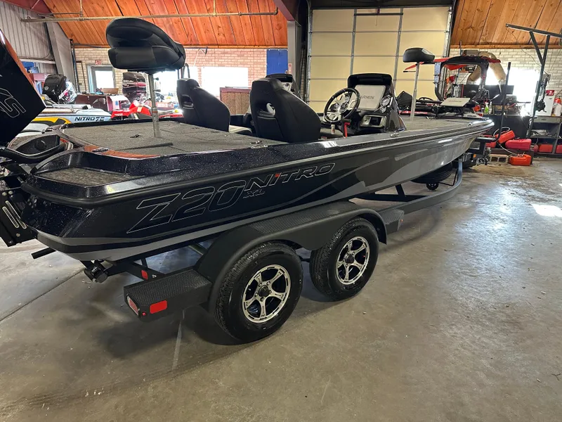 Slide: The Image of 2025 Nitro Z20 XL Pro boat in a garage, featuring sleek design and dual-axle trailer. - 4
