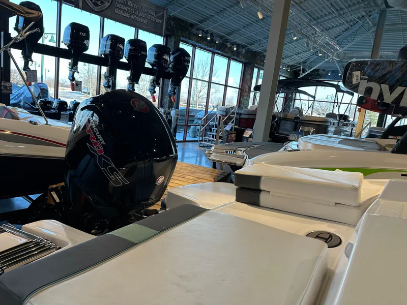 Slide: The Image of 2025 Tahoe T18 boat in showroom with outboard motor display. - 2