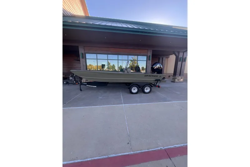 The Image of 2025 Tracker Grizzly 2072 CC boat on trailer outside a building. - 0