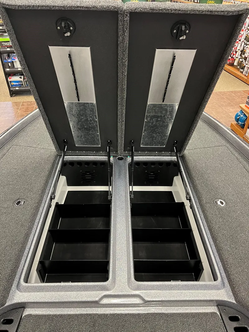Slide: The Image of 2025 Nitro Z21 XL boat storage compartments open, showcasing organized interior space. - 11