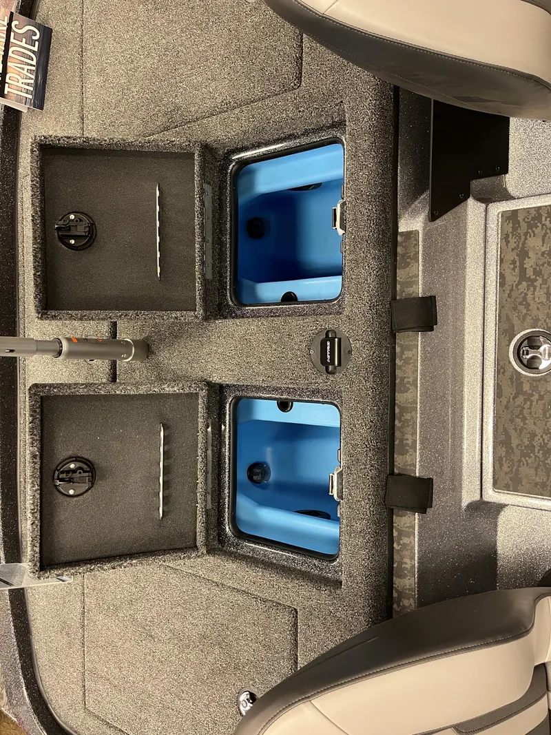 Slide: The Image of 2025 Nitro Z21 XL boat storage compartments with blue interior. - 12