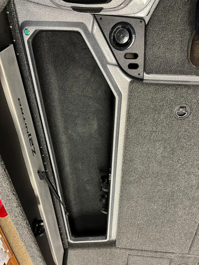 Slide: The Image of 2025 Nitro Z21 XL boat storage compartment with textured interior and secure latch. - 14