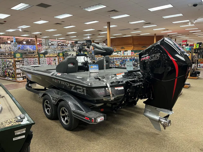 Slide: The Image of 2025 Nitro Z21 XL boat displayed indoors with powerful engine. - 3