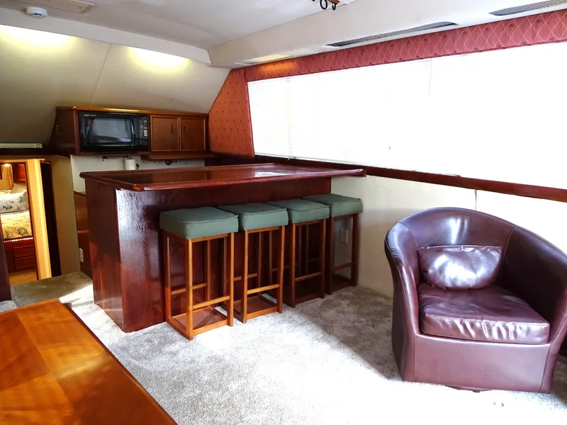 Slide: The Image of Luxurious interior of 1987 Ocean Yachts 48 with bar and leather seating. - 12