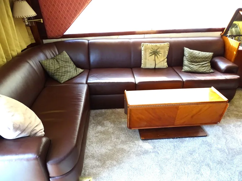 Slide: The Image of Luxurious leather seating in 1987 Ocean Yachts 48 interior with wooden table. - 13