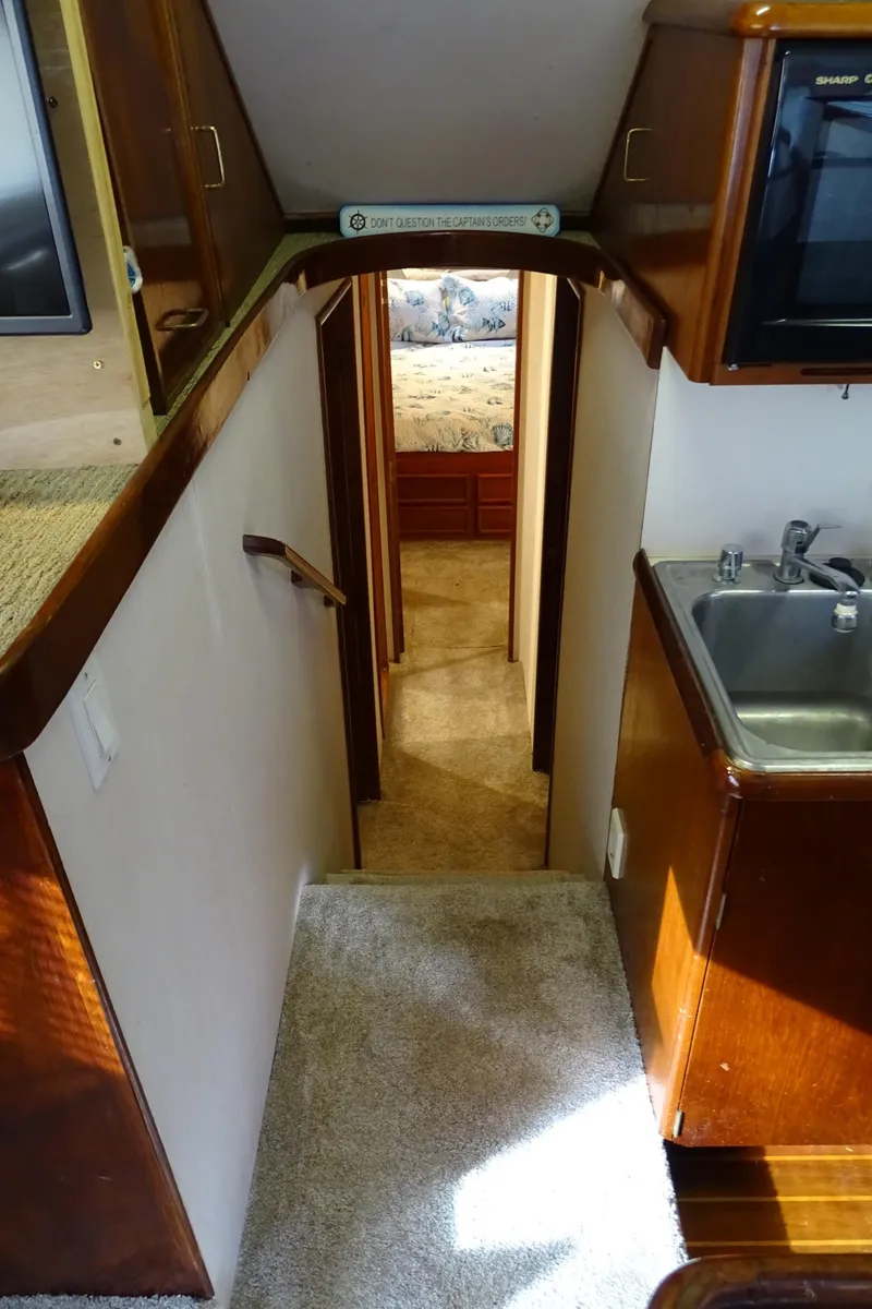 Slide: The Image of Interior view of 1987 Ocean Yachts 48, featuring hallway and kitchenette. - 18