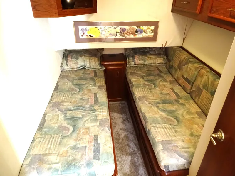 Slide: The Image of 1987 Ocean Yachts 48 cabin with twin beds and patterned bedding. - 21