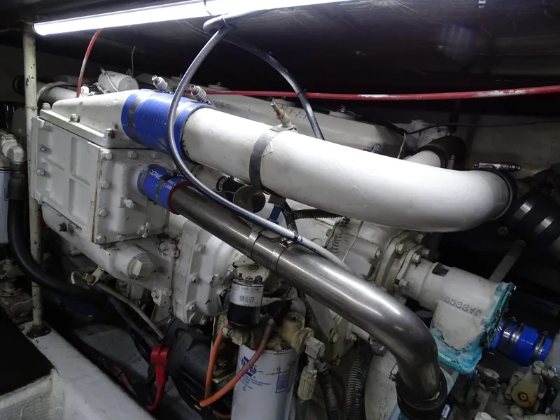 Slide: The Image of Engine room of 1987 Ocean Yachts 48, showcasing complex machinery and piping. - 27