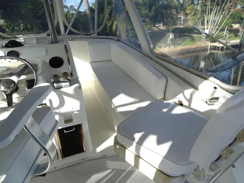 Slide: The Image of Interior of 1987 Ocean Yachts 48, featuring white seating and helm area. - 30