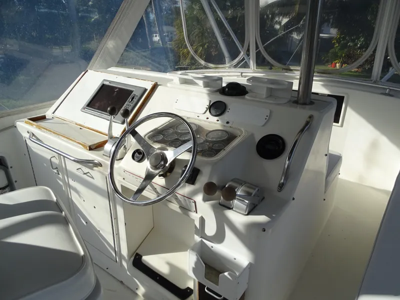 Slide: The Image of 1987 Ocean Yachts 48 helm with steering wheel and navigation instruments. - 31