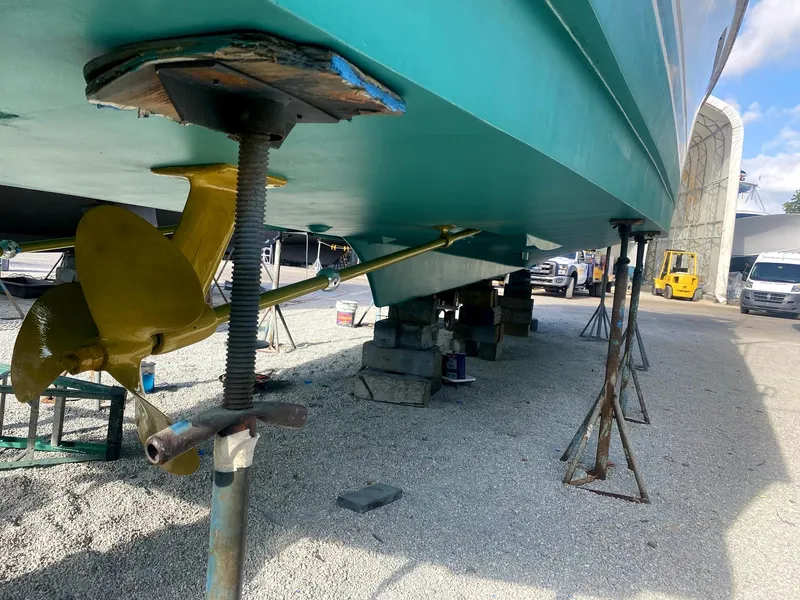 Slide: The Image of 1987 Ocean Yachts 48 on stands, showing hull and propeller in boatyard. - 38