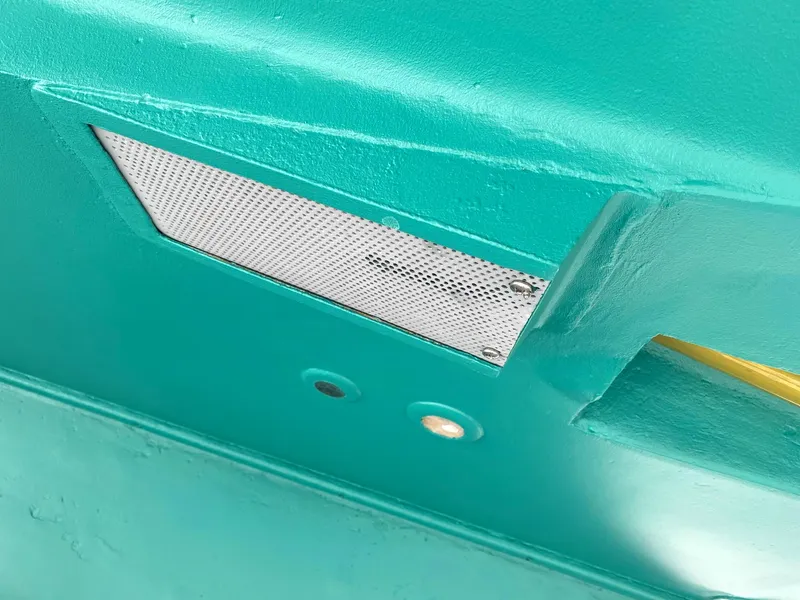Slide: The Image of Close-up of a 1987 Ocean Yachts 48 boat hull with teal paint and vent detail. - 39