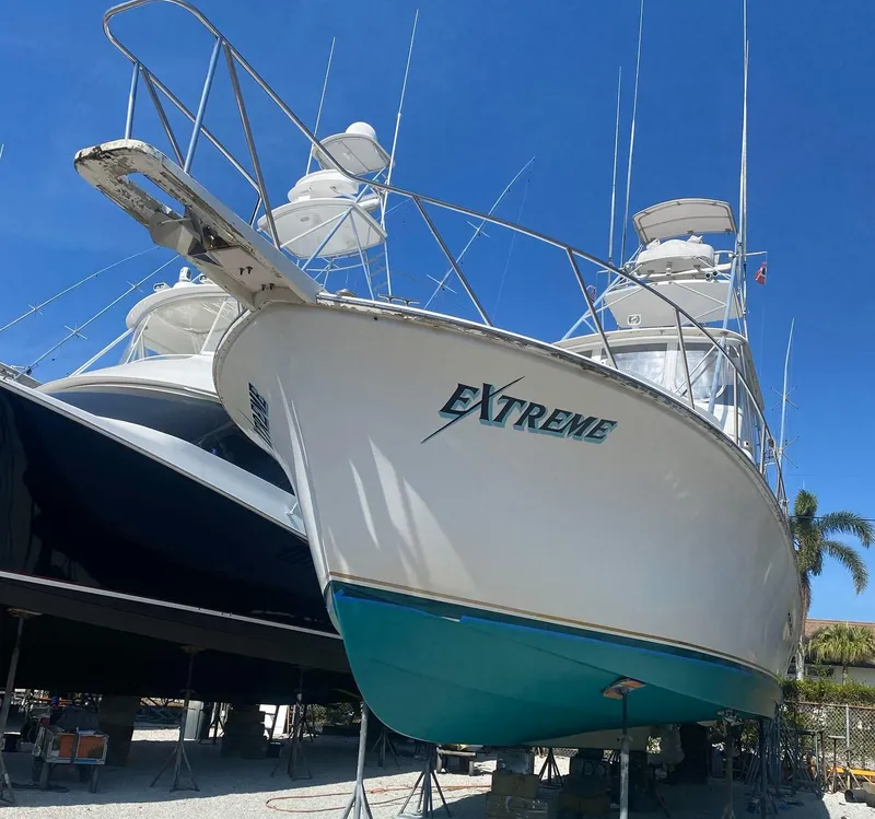 Slide: The Image of 1987 Ocean Yachts 48 boat named "Extreme" on dry dock under clear blue sky. - 4