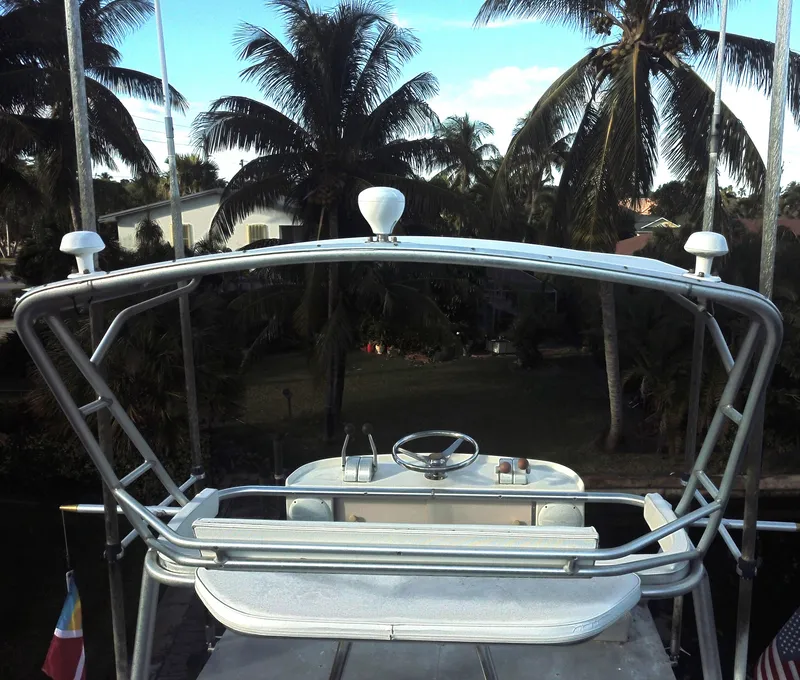 Slide: The Image of 1987 Ocean Yachts 48 helm with tropical palm tree backdrop. - 7