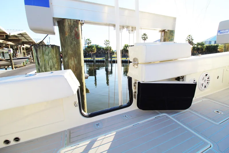 Slide: The Image of 2017 HCB Suenos boat deck with open side door, docked by water. - 13